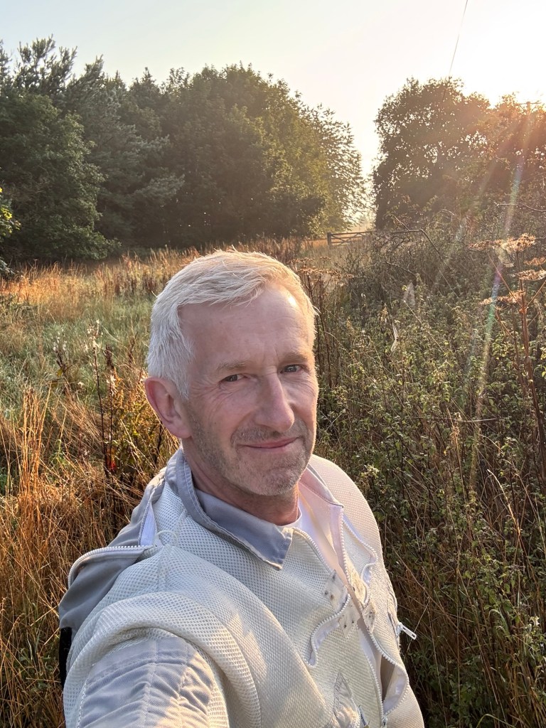 Dave and Steven of 3Farm Honey beside a beehive in the Northumberland countryside.